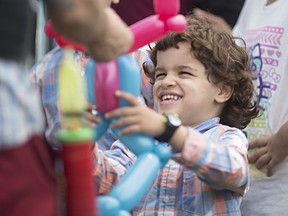 Elyas Elmeddah, 4, is excited to receive a balloon animal from Bill Nuvo at the 2016 Eid Festival at the Rose City Islamic Centre, Saturday, July 9, 2016.