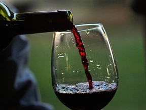 A glass of red wine being poured in 2014.