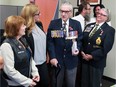 NDP Members of Parliament Irene Mathyssen, left, and Tracey Ramsey listen to concerns of area veteran Larry Costello, centre, and Gayle Brown, Royal Canadian Legion in Essex, Monday.  Behind, MP Cheryl Hardcastle chats with Greg Brownlie, RCL Brach 261.