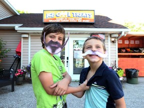 Wyatt Shepley, left, and his brother Eli Shepley have a little fun acting as Mayor McMilkshake and Councilman Cool Treats in Essex, Ontario on July 8, 2016.