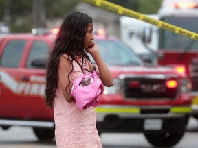 Five people were displaced after fire ripped through a semi-detached home in the 2200 block of College Ave. on Wednesday, July 6, 2016, in Windsor, Ont. A young girl who lived in the home holds her kitten at the scene of the fire.