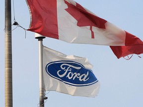 The Ford corporation flag and the Canada flag fly at the Ford Essex Engine Plant in Windsor in 2012.