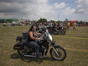 Motorcyclists take part in biker games at the Hogs for Hospice Motorcycle Rally outside the Roma Club in Leamington, Sunday, July 31, 2016.