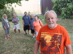 Bernie Ladenthin, front, stands in front of other County Road 34 residents Annie Ladenthin,  from left, John Chovan, Brad Bloomfield,  Gary Pozzo and Lynne Brunini on July 29, 2016. The group gathered to discuss their concerns with to Agriculture Technology Inc. burning greenhouse pepper plants that were infected with bugs.