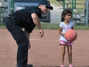 The LaSalle Hang Out for Youth group kicked off their summer program at the Gil Maure Park on Thursday, July 14, 2016.   The group provides save haven for youth by providing help with school work and personal development programs, healthy snacks and physical activities. The young participants along with local police and fire service personnel participated in a game of kick ball. LaSalle firefighter Jeff Meloche gives Rhea Kapoor, 5, some direction during the game.
