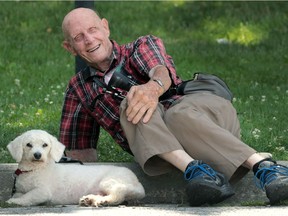 George Garvey, 89, and his dog Rider enjoy a shady spot along the Detroit River on Monday, July 25, 2016 in Windsor, Ont. Garvey rescued the dog from the local Humane Society a month ago and has quickly bonded with the pooch.