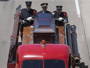 A funeral procession for Mason Macri makes its way east on Highway 401, Saturday, July 2, 2016.