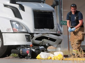 A Tecumseh firefighter is shown at a fatal motorcycle accident on Malden Road in Tecumseh, Ont. on Monday, July 11, 2016. The motorcyclist collided with a semi head on just south of South Talbot Road.