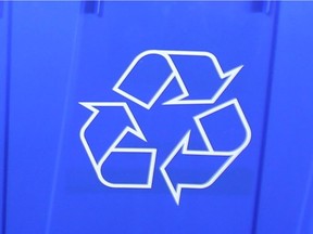 A recycling logo is photographed on a blue recycling bin on March 7, 2012.