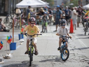 Jacob Fearday, 7, left, and Logan Fearday, 6, compete in a slow ride competition organized by Bike Friendly Windsor Essex during Open Streets Windsor on July 17, 2016.