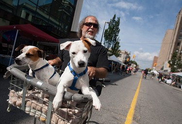 Rico Prosperi enjoys the open roads with his dogs Ace and Ziter during Open Streets Windsor, Sunday, July 17, 2016.
