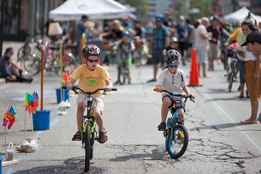 Jacob Fearday, 7, left, and Logan Fearday, 6, compete in a slow ride competition organized by Bike Friendly Windsor Essex during Open Streets Windsor, Sunday, July 17, 2016.