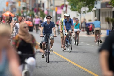 Cyclists and pedestrians in Walkerville enjoy 8 km of streets closed to motor vehicles during Open Streets Windsor, Sunday, July 17, 2016.