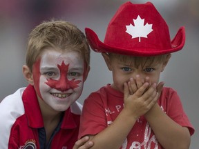 Aaron Bondy-Hotchkiss, 8, left, and his brother Beckem Hotchkiss, 3, celebrate Canada Day at the Canada Day Parade on Wyandotte Street East in downtown Windsor, Friday, July 1, 2016.