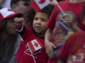 Abriel Notov, 3, gets excited as the floats pass by at the Canada Day Parade on Wyandotte Street East in downtown Windsor, Friday, July 1, 2016.