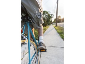 Riding a bicycle on the sidewalk. Photo by Getty Images.