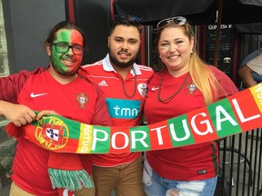 Portuguese-Canadian soccer fans Branden Mendes, Brandon Rino, and Alexis Pedro show their joy in downtown Windsor after Portugal won the UEFA European Championship cup on July 10, 2016.