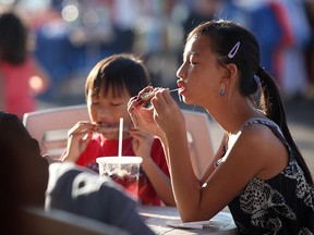 Kids chow down on ribs at the Riverfront Festival Plaza in this 2012 file photo.