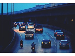 Road traffic at dusk. Motorcycles and cars. Photo by Getty Images.