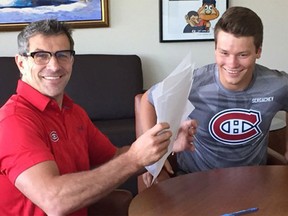 Spitfires defenceman Mikhail Sergachev, right, signs an entry-level deal with the Montreal Canadiens alongside Habs GM Marc Bergevin on July 1, 2016..