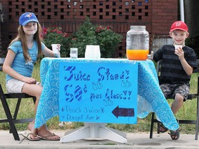 Cadence Rau, 11, and her brother Micah Rau, 9, are shown at the juice stand they set up in front of their home in the 1000 block of Dougall Ave. in Windsor, ON. on Tuesday, July 5, 2016.They said business was brisk with the hot humid weather recently.