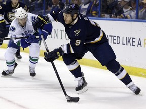 St. Louis Blues' Steve Ott, right, controls the puck as Vancouver Canucks' Linden Vey watches during the second period on March 30, 2015, in St. Louis.