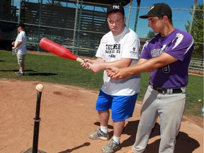 Tecumseh Thunder player Casey Boutette, right, coaches Alvin Matte at home plate during annual Tecumseh Baseball Club's Fun Day Camp at Lacasse Park July 26, 2016. (NICK BRANCACCIO/Windsor Star)