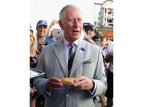 PORT ISSAC, ENGLAND - JULY 19:  Prince Charles, Prince of Wales (known as the Duke of Cornwall in Cornwall) is given a Cornish Pasty as he visits Nicki's Bakery on July 19, 2016 in Port Issac, England.