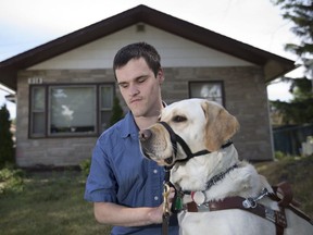 Matthew Dierckens and his Yellow Lab guide dog, Marilyn, are pictured in front of his home in East Windsor, Sunday, July 10, 2016.