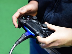 A boy uses a joystick to play a farming simulation video game in this February 26, 2015 file photo.