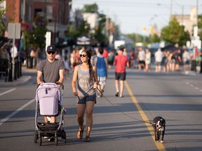 Jackie Giannotti and Gregy Mayville stroll down Wyandotte with their daughter Olive Mayville and Chauncey, their Boston Terrier, during the Walkerville Art Walk and Rock, Saturday, July 23, 2016.