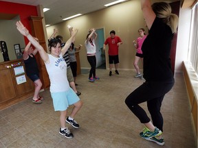 Nathalia Drkulec dances while instructor Kellie Holgate (right) teaches a dance class for Autistic students at Roots 2 Wings in Windsor on Monday, July 11, 2016.