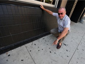 Paul Twigg, of the Windsor Downtown Business Improvement Association, looks over the gum that lines the downtown streets on July 12, 2016.