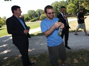 Pokemon Go players Jeffrey Pellizzari, left, Luke Van Hooren and Sam Isiac converge on Jackson Park in Windsor on Wednesday, July 13, 2016. The app based game, which hasn't even officially been released in Canada, is hugely popular — especially with those in the their 20s that grew up with the original Pokemon.