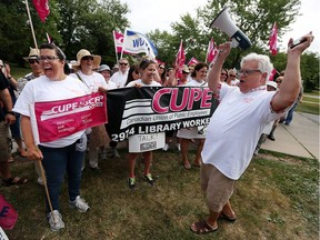 CUPE president Fred Hahn, right, rallies striking library workers in front of the Tecumseh Library on Thursday, July 14, 2016.