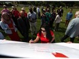 Nadine Abiraad signs a petition during an anti-Islamophobia news conference at Dieppe Park in Windsor on July 4, 2016.