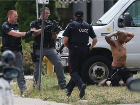 Windsor police surround a residence and take several people into custody near the corner of Glengarry Avenue and Wyandotte Street in Windsor on Tuesday, July 5, 2016. Police closed off several blocks around 1 p.m. as they cleared the building.