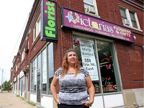 Kathy Molenaar, owner of Victoria's Flowers and Gifts, stands in front of her store at 212 Erie St. W. on Thursday, July 28, 2016. Molenaar says a plague of crime in the area has forced her to move her business.