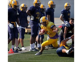 In this file photo, University of Windsor Lancers Beau Lumley, centre, turns the corner after a short pass during drills at Alumni Field, Monday, Aug. 17, 2015. (NICK BRANCACCIO/The Windsor Star)