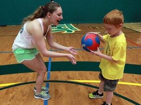 Canadian Tire Jumpstart Games Day instructor Lauren Duggal, left, encourages Alex Johns-Loreti, 7, during obstacle course at St. Clair College's SportsPlex Wednesday July 13, 2016.