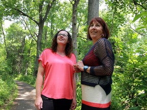 Crissy Drew, left, and Cynthia Brown pause for a moment on July 19, 2016 at the Ojibway Nature Centre where the mental health experts take young people with mental illnesses for walks in the woods as part of a pilot project called Mood Walks.