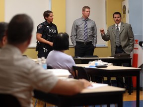 Windsor police senior Const. Cealia Gagnon, from left, OPP detective Const. Mike Lane and Windsor police director of planning and physical resources  Barry Horrobin speak to area pharmacists  on July 21, 2016.