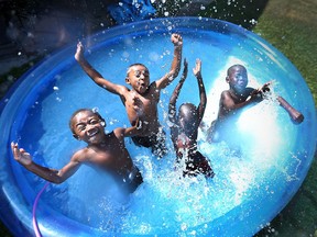 Chance Van Hoorn, 4, left, Julian Morgan, 4, Douth Jock, 6, and Lulu Jock, 6, cool off in the pool on July 22, 2016.