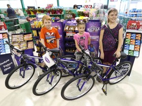 Connor, 9, from left, Makayla, 8, and Skye are all smiles after receiving new bicycles from Mondelez Canada on July 22, 2016.