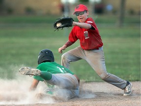 Windsor West second baseman Colin Haskell catches the ball as an East Nepean baserunner slides in safely during the  Junior League Ontario Championships at Central Park in Windsor, Ont., on July 27, 2016. The East Nepean Eagles defeated Windsor West 4-1.
