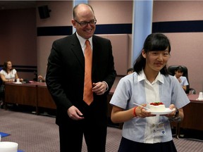 Windsor Mayor Drew Dilkens cuts the welcome cake for Nayuu Nagasawa on her 16th birthday Wednesday July 27, 2016.