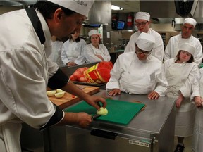 Students listen and watch Chef Leo Grado, left, in the kitchen of Eatery 101, A Taste of Class at St. Clair College's main campus on Monday July 4, 2016.