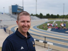 Jess Dixon, associate professor of sports management for the department of kinesiology at the University of Windsor is pictured at the school's Alumni Field on July 4, 2016.