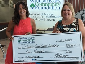 Windsor Cancer Centre Foundation manager Houida Kassem, left, poses with Shelley Atkinson, widow of murdered Windsor police officer Const. John Atkinson. The cancer foundation has received a $4,000 donation from the John Atkinson Memorial Golf Tournament.