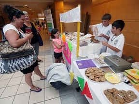 Brennan Tedley and Jaxson Nosella (right) sell baked treats for W.E. Care for Kids at Windsor Regional Hospital in Windsor on Wednesday, August 10, 2016. The group of kids was hoping to top last years total of $1800 by reaching $3600. (TYLER BROWNBRIDGE / WINDSOR STAR)